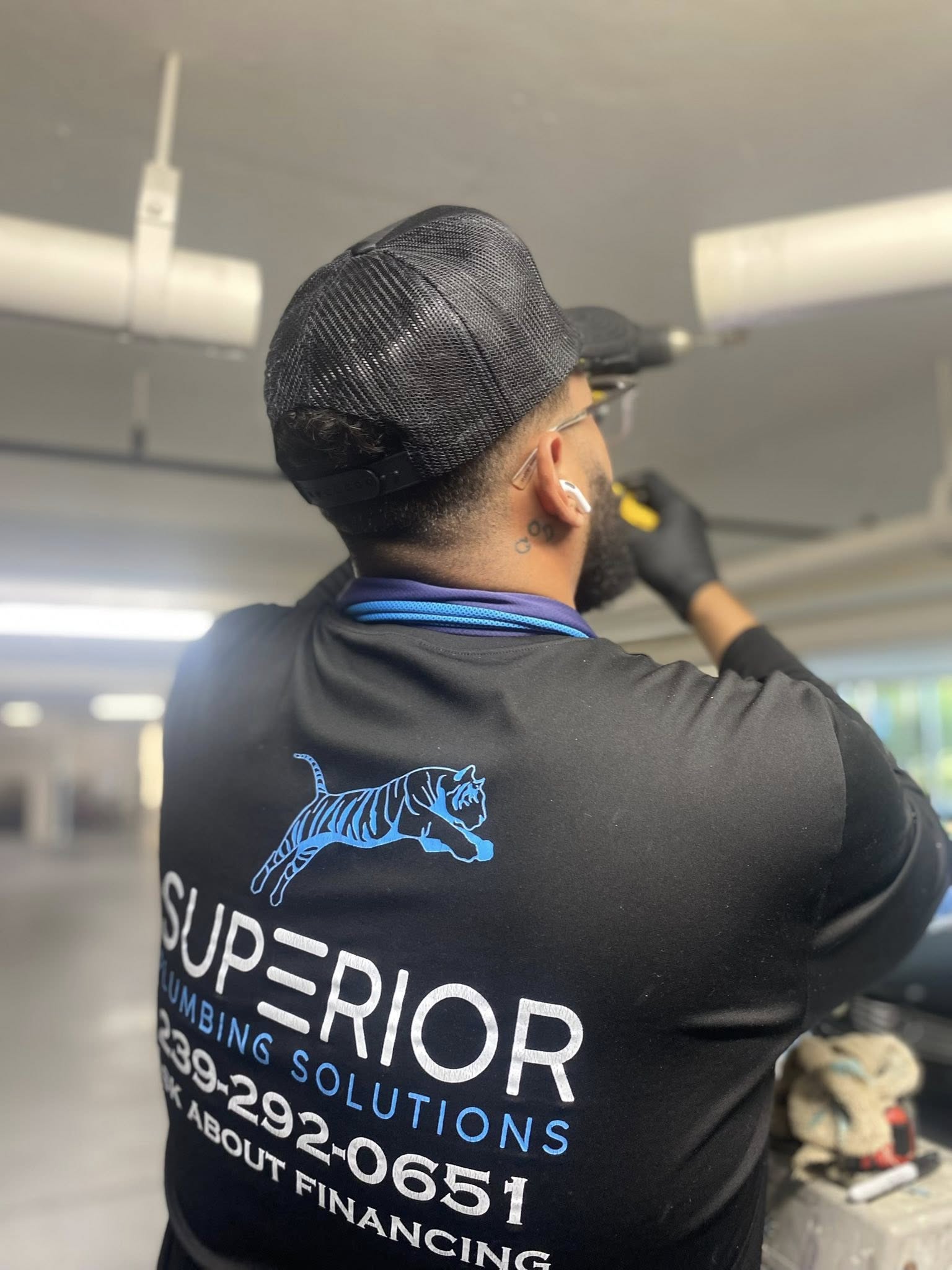 Plumber in Cape Coral, FL carefully assessing a commercial system.