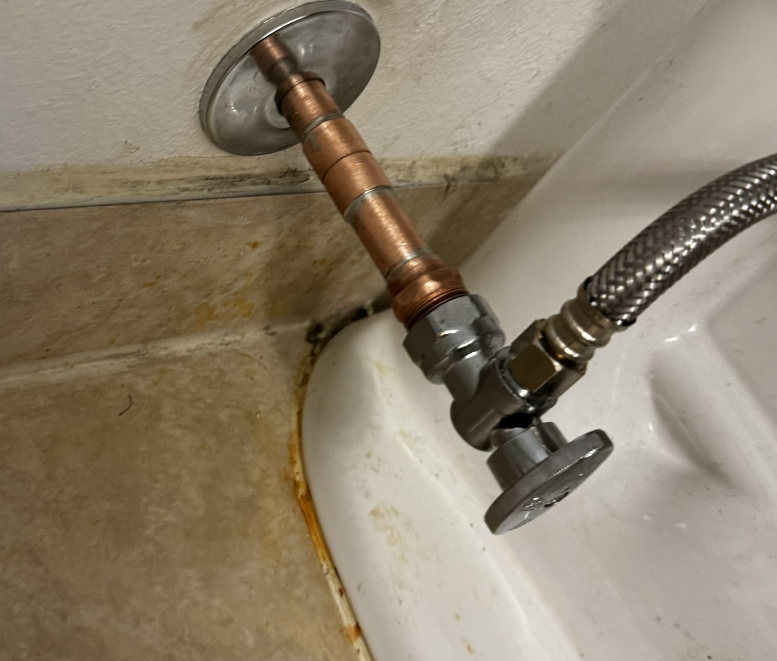 New angle stop shut-off valve and braided supply line installed under a fixture in Cape Coral, FL.