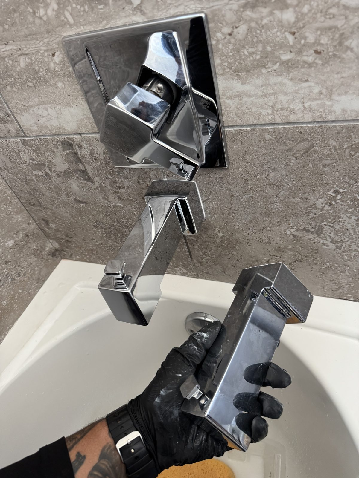 Replacing a modern chrome square bathroom faucet in a Cape Coral, FL home.