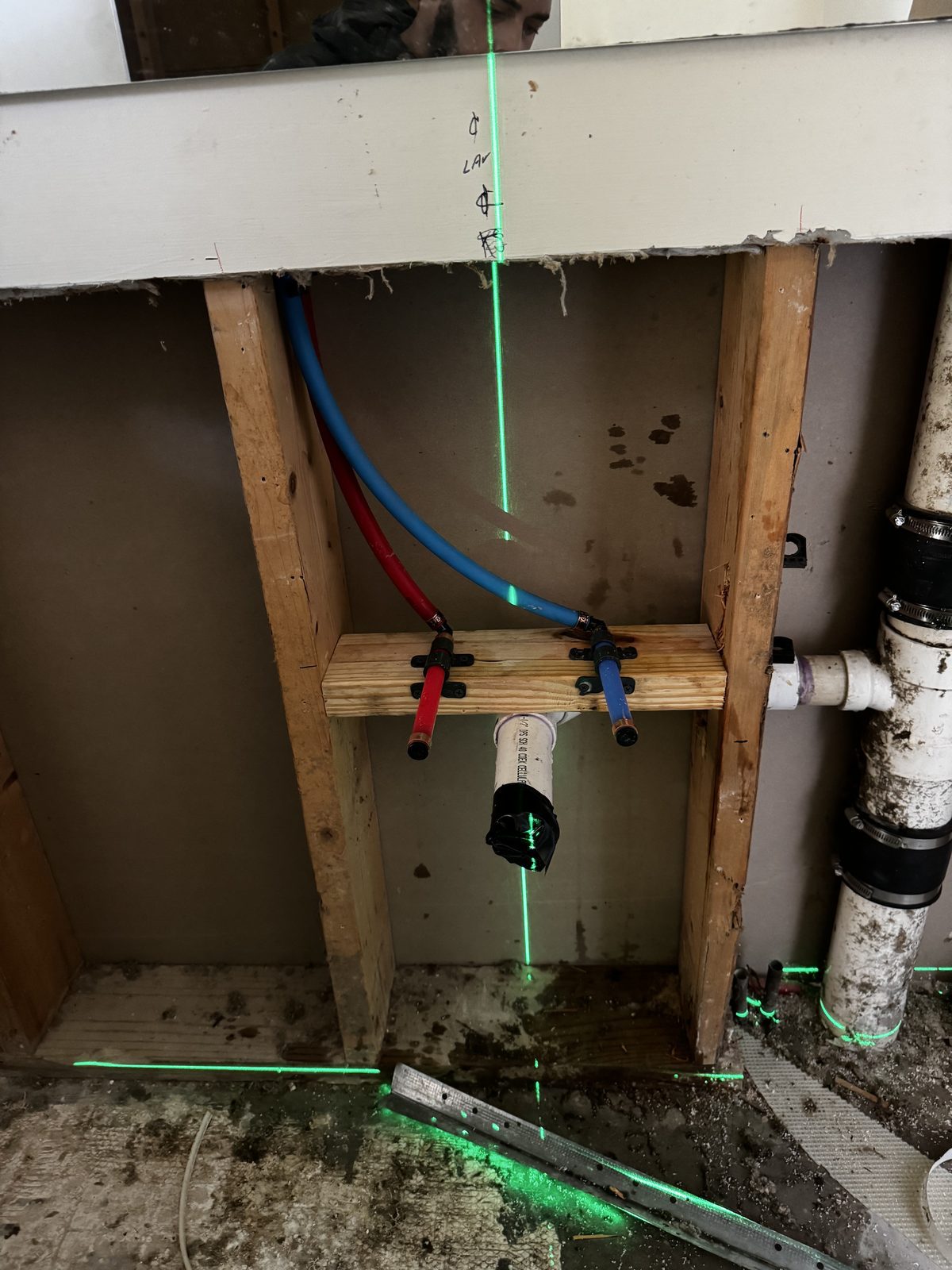 PEX hot and cold water lines roughed in to a laser level during a bathroom project in Cape Coral, FL.